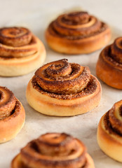 Cinnamon rolls close up. Cinnamon buns on a baking sheet. Selective focus