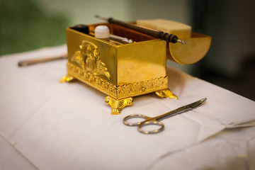 attributes of an Orthodox priest for baptism. Baptism in the font. Sacrament of baptism. Child and God. Christening candle Holy water font. The priest baptize.