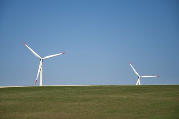 Fototapeta premium Wind turbines. Renewable energy with wind turbines. Windmills for electric power production.