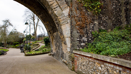 A view through the stone archway towards Castle Meadow Gardens in the city of Norwich, Norfolk