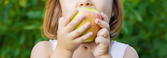 Child with an apple. Selective focus. nature