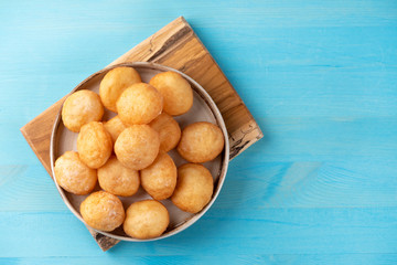 Baursak - traditional Kazakh (Asia) food \ national bread in plate on blue wooden background, top view