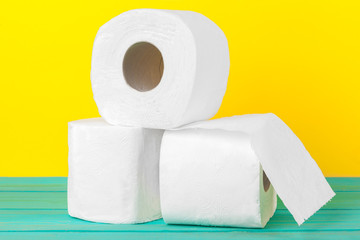 Toilet paper stacks  on bright yellow background
