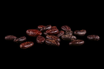 Roasted beans. Cocoa beans and coffee beans isolated on black background.
