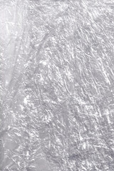 Transparent crumpled plastic packing texture background, basis backdrop
