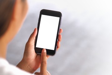 The woman's hand is holding the phone in his hand. The phone has a white screen.