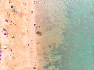 Fototapeta na wymiar Aerial view of sandy beach with tourists swimming in beautiful clear sea water - Taiwan North Coast , shot in Sanzhi District, New Taipei, Taiwan