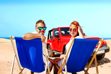 Summer car on beach and two lovers 