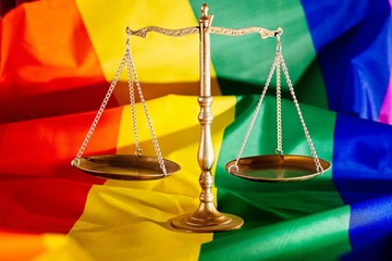 Scales of justice symbol of law and justice with lgbt flag