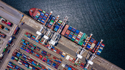Aerial top view container cargo ship unloading in import export business logistic and...