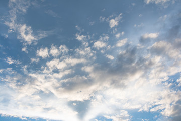 Blue sky with clouds background with sun rays