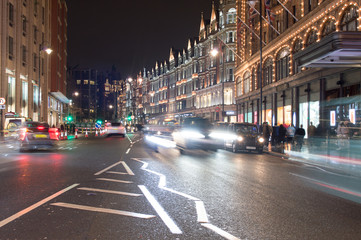 Fototapeta na wymiar London, Uk, january 2019. Night city view, a characteristic detail of the busy city life, taxis, people and wet streets.