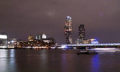 Obraz na płótnie Canvas London, UK, january 2019. City skyline at night. City lights reflecting in the Thames river water