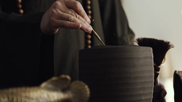 Tea master preparing hot coals for tea ceremony