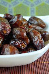 sweet algerian arabic dates fruits on a white plate