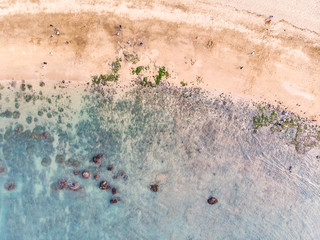 Aerial view of sandy beach with tourists swimming in beautiful clear sea water - Taiwan North Coast , shot in Sanzhi District, New Taipei, Taiwan