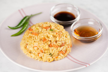 Fried Rice with vegetables and sauce on a plate \ in a bowl
