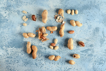Tasty peanuts on color background