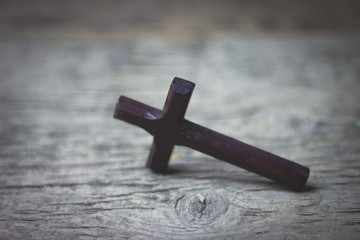 wooden cross on wooden table