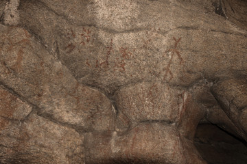 Ancient images of people on the wall of the cave history of antiquities, archeology.