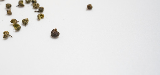 varies seasoning scattered in white background, pepper,shirmp,salt,curry,