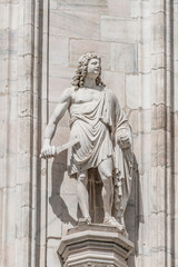 Fototapeta premium Decorative Religious figure at facade of the Cathedral of Milano, Milan, Italy