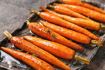 Plate with tasty cooked carrot on table, closeup