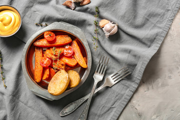 Plate with cooked vegetables on table