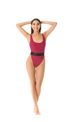 Beautiful young woman in swimming suit on white background