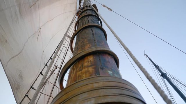 Lowering Ship Sail On Traditional Gaff Rig Boat Mast.