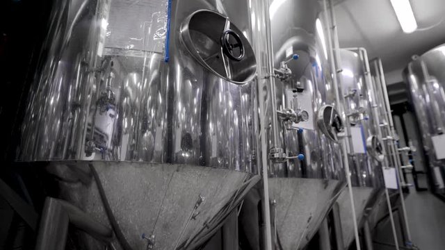 camera is moving along shine modern tank for mashing malt for brewing beer in brewery plant