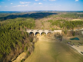 Aerial view of old concrete railway bridges in Stanczyki during spring season, Mazury, Poland