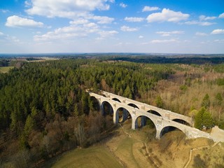 Aerial view of old concrete railway bridges in Stanczyki during spring season, Mazury, Poland