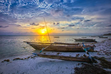 Fotobehang Boat of a fisherman on a tropical beach, Zanzibar, Tanzania © Venera