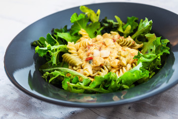 Salad made from radiatori cooked pasta, goat cheese and oil vinaigrette