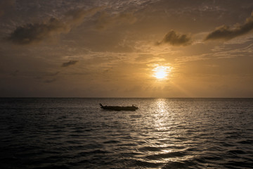 Naklejka na ściany i meble Boat of a fisherman on a tropical beach, Zanzibar, Tanzania