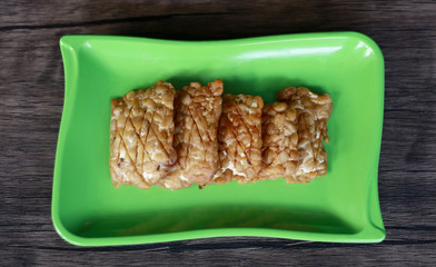 Fried tempeh on wood background. Indonesian traditional food.