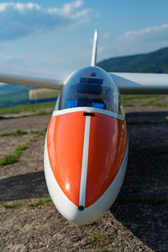 the orange nose of the plane is a glider that lies on the ground