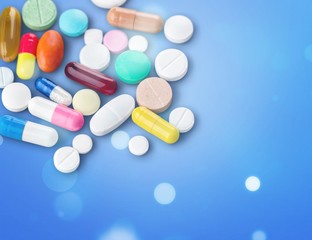 Colorful pills and tablets on background