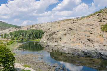 Fototapeta na wymiar Columnar jointed volcanic rocks around Arda River behind the Studen Kladenets (Cold well) dam, Bulgaria