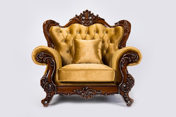 Luxurious vintage gold armchair on white background