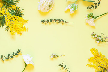 Floral spring frame with mimosas on the white background. Top view. Copy space