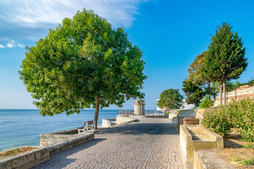 A beautiful street in Nessebar ancient city on the Bulgarian Black Sea Coast. Nesebar or Nesebr is a UNESCO World Heritage Site. A street in Nessebar on a sunny day with blue sky, Bulgaria