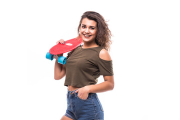 Portrait of teen girl in sunglasses posing with skateboard while standing isolated over white background