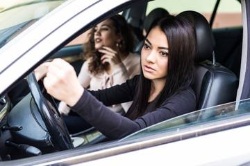 Young woman shaking hers fist sitting in vehicle drive her car