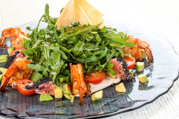 Salad with tiger shrimps, arugula, avocado and grapefruit under oyster sauce