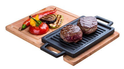 Fillet of veal minion with grilled vegetables on a wooden board