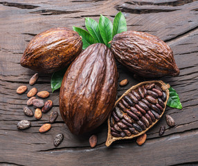 Cocoa pod and cocoa beans on the wooden table. Top view.