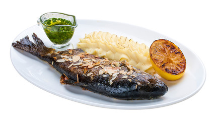 Baked trout with almonds and mashed potatoes. On white background