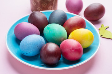 Fototapeta na wymiar Colorful Easter eggs as an attribute of Easter celebration. Pink background.